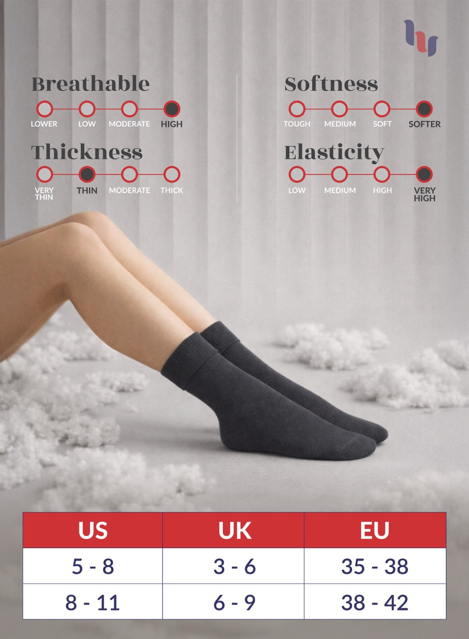 Charcoal gray socks with measurement chart on a gray background