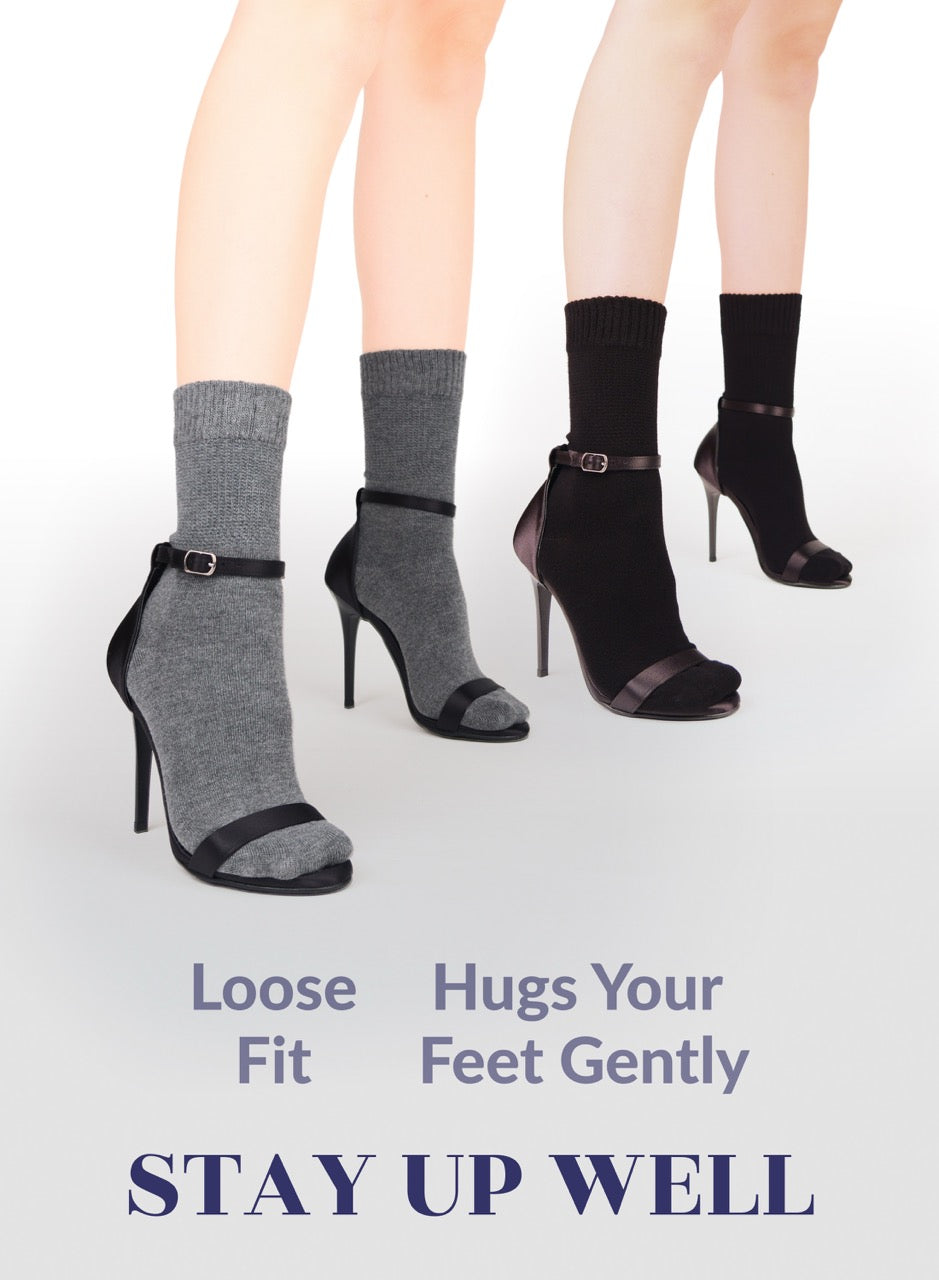 High-heeled shoes with socks worn, featuring text about sock fit and comfort.