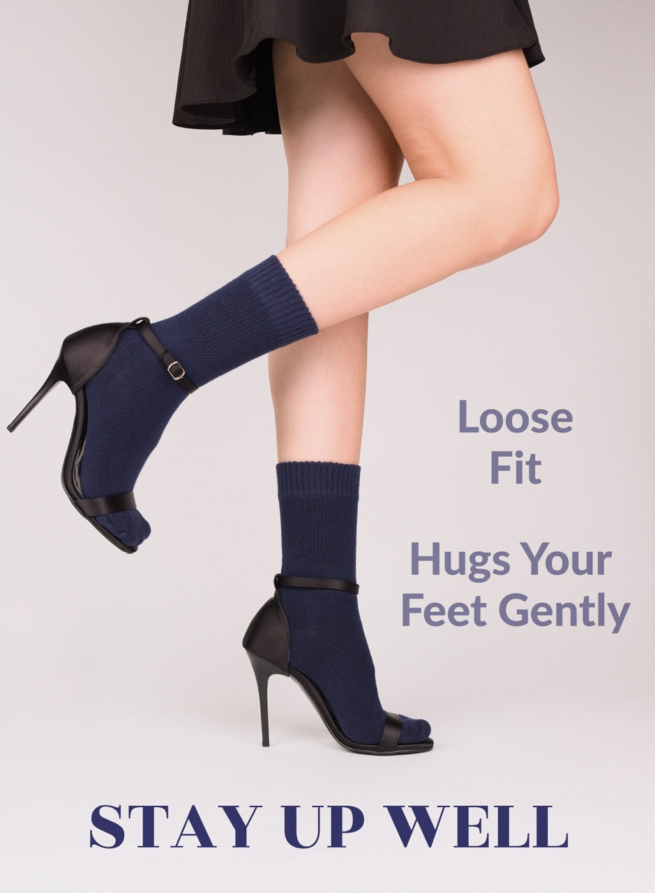 Navy blue socks worn with black high heels on a plain background, featuring text about sock fit.