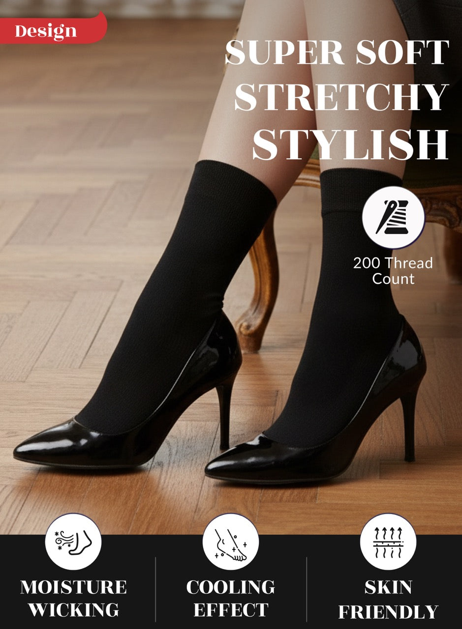 Black high-heeled shoes worn with black socks on a wooden floor, emphasizing comfort and style.