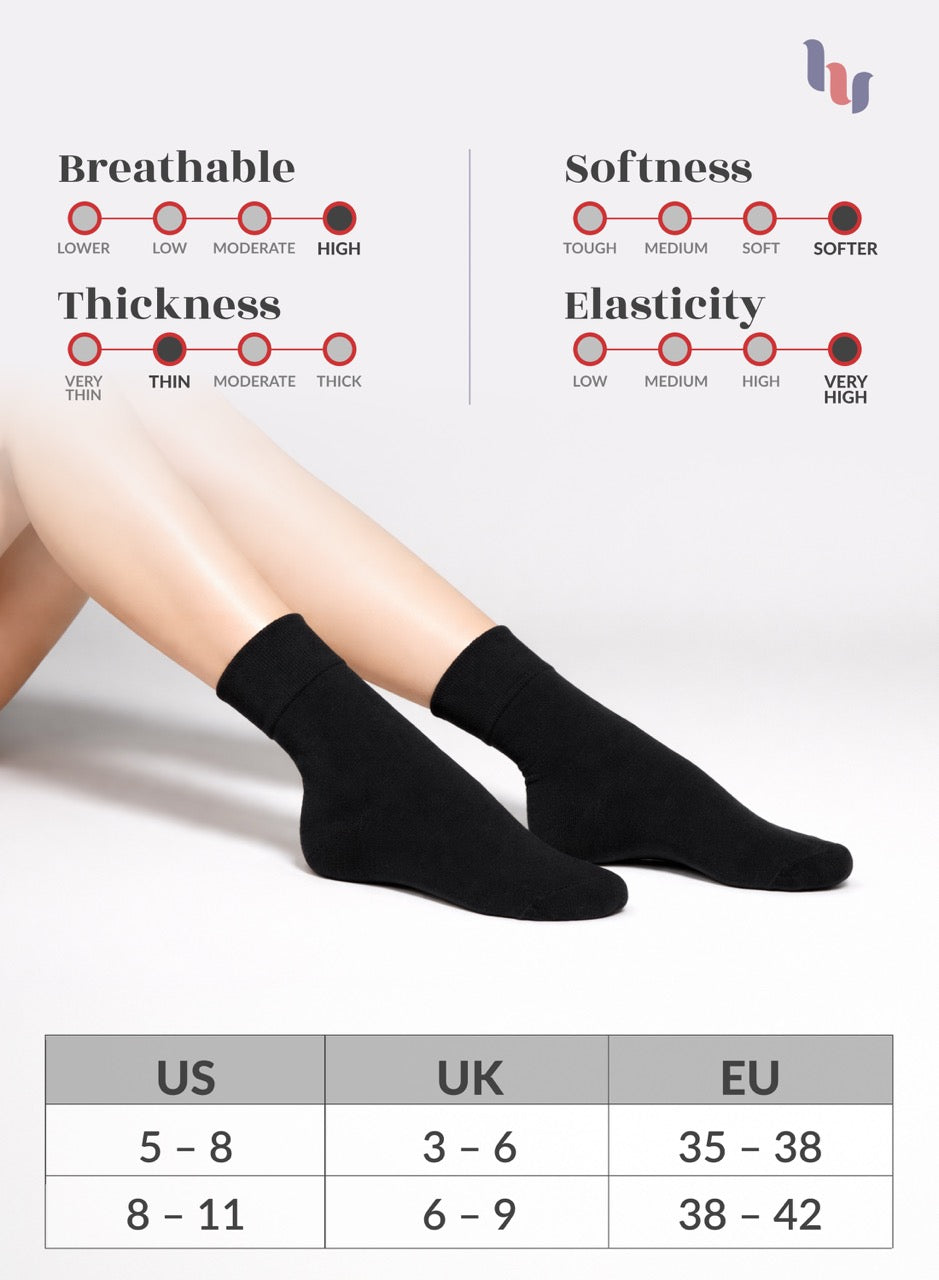 Black socks with measurement chart for US, UK, and EU sizes on a light gray background.