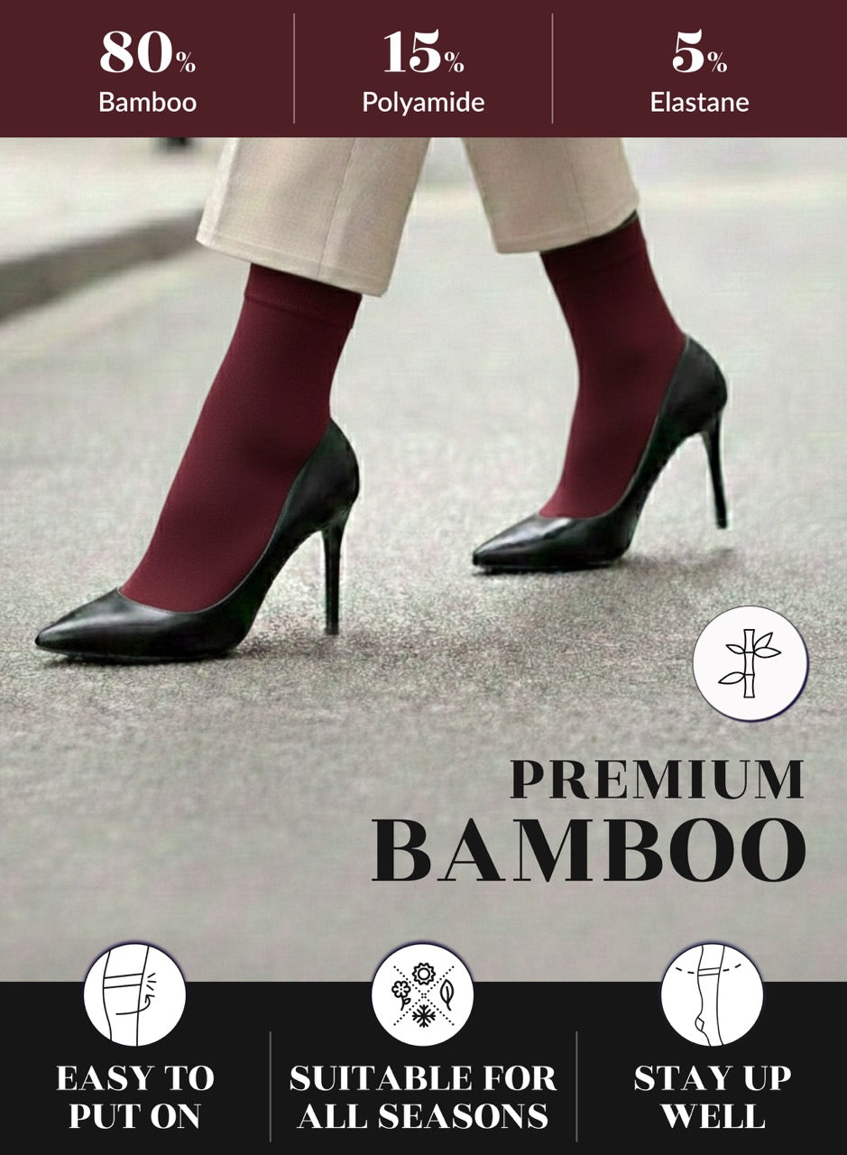 Burgundy socks worn with black high heels on a gray background, featuring bamboo sock成分 and benefits.