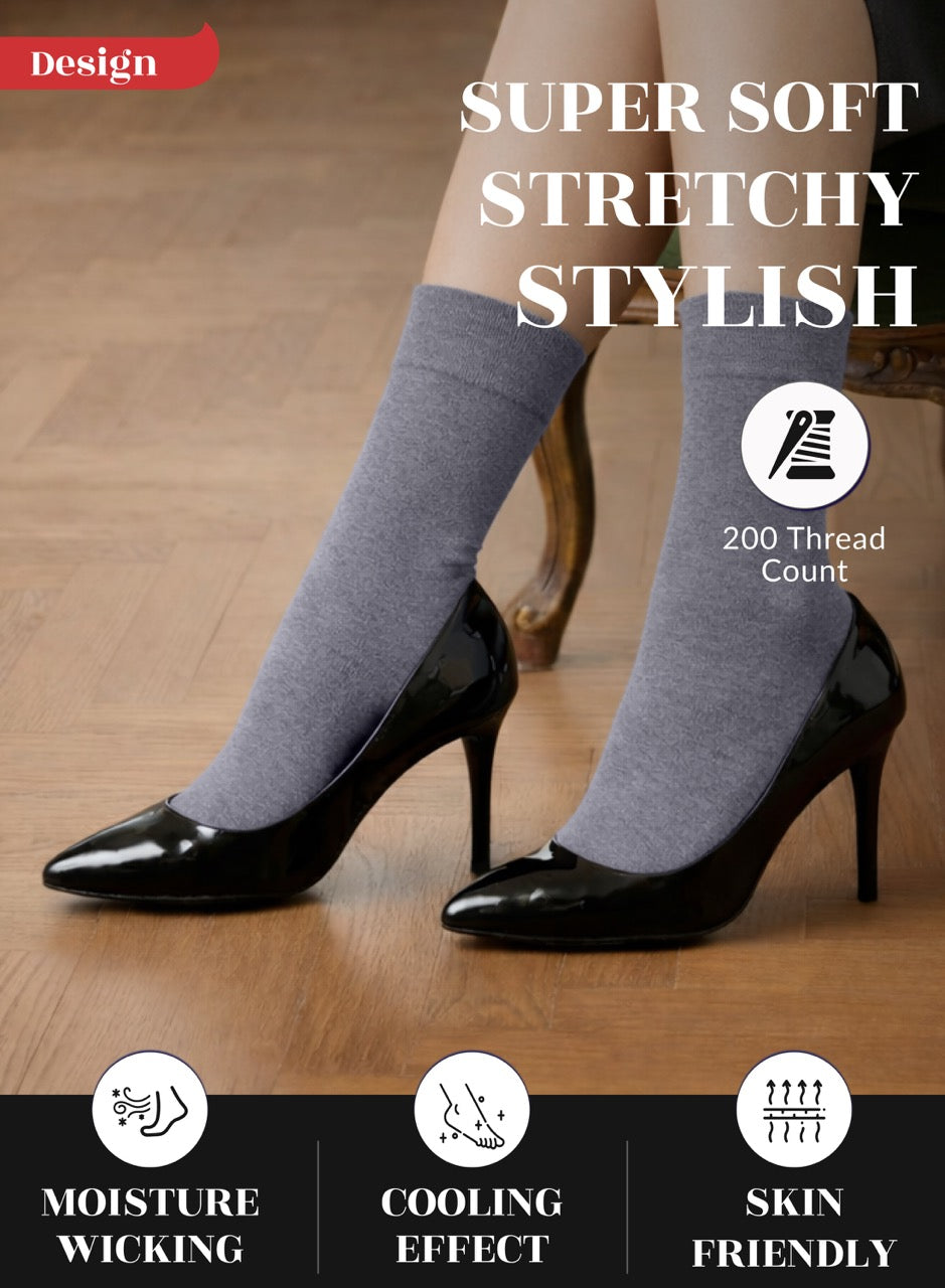 Gray socks worn with black high heels on a wooden floor, featuring text about sock properties.