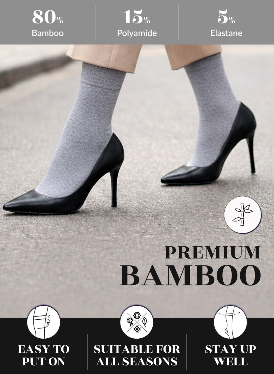 Light grey socks worn with black high heels on a neutral background, featuring text about material composition and product features.