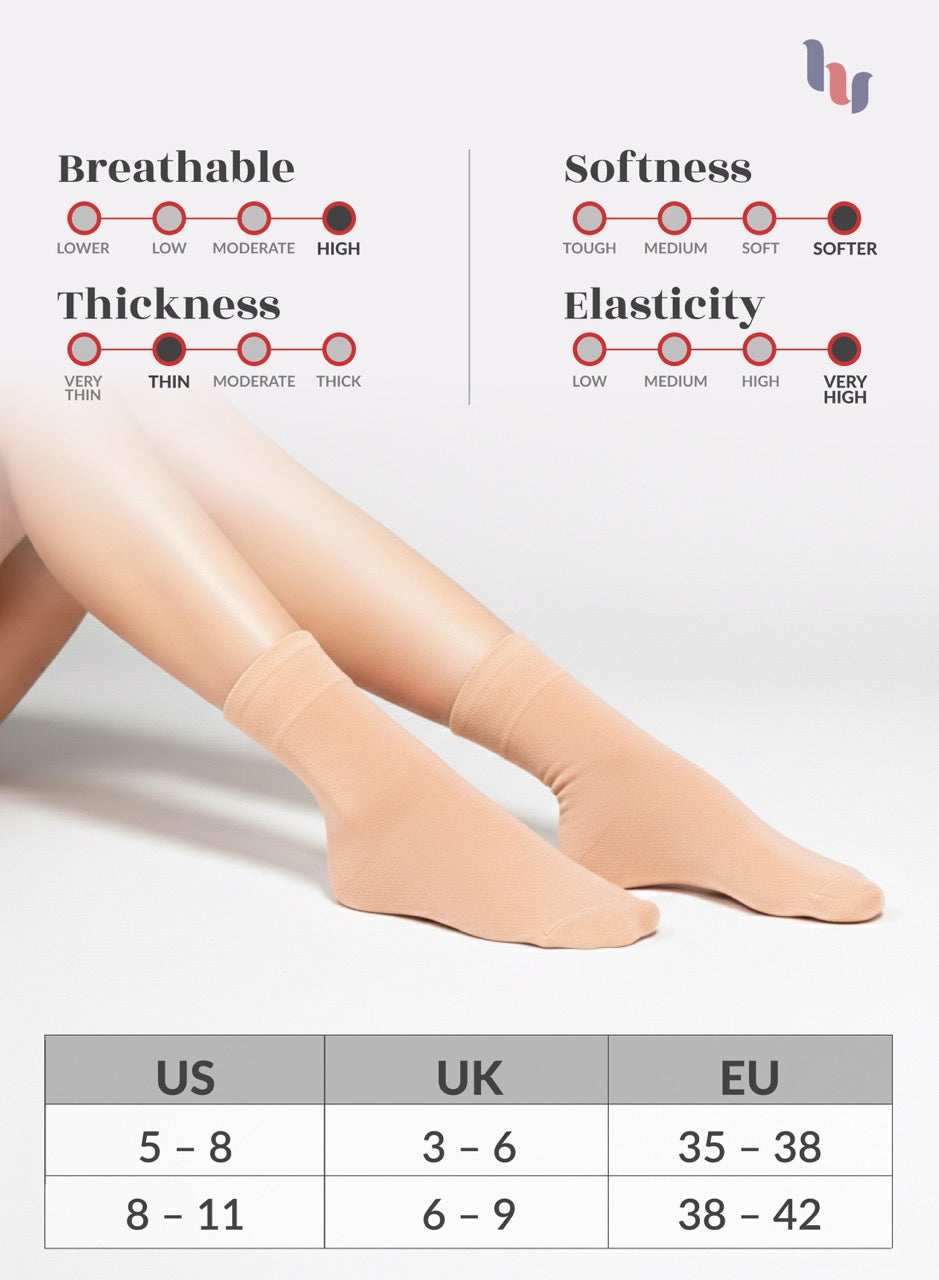 Legs wearing Peach Rose socks with measurement chart on a light gray background