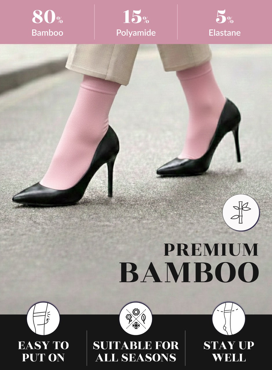Pink bamboo socks worn with black high heels on a gray background, featuring text about material composition and product benefits.
