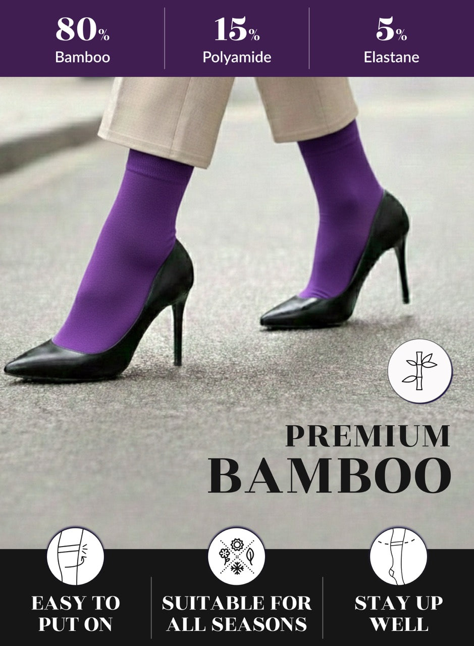 Purple socks worn with black high heels on a gray pavement background, featuring bamboo sock information.