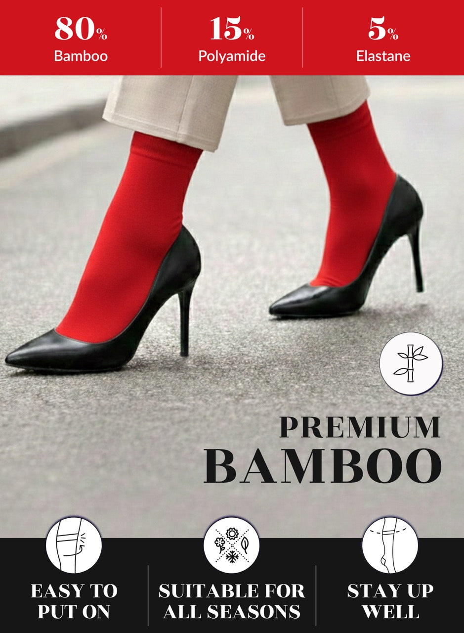Red socks with black high heels on a gray surface, featuring bamboo sock information.