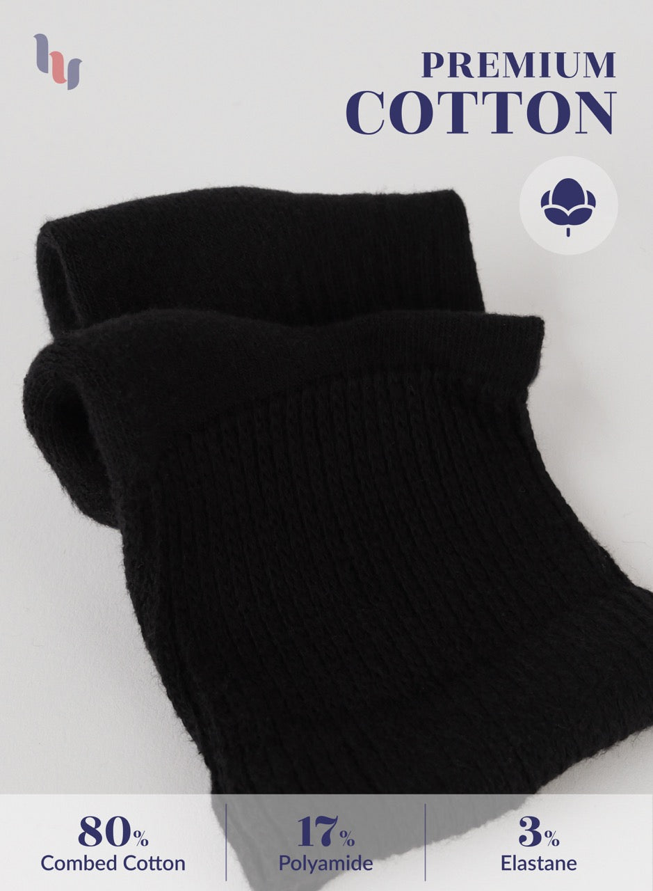 Black socks with premium cotton label and material composition details on a white background