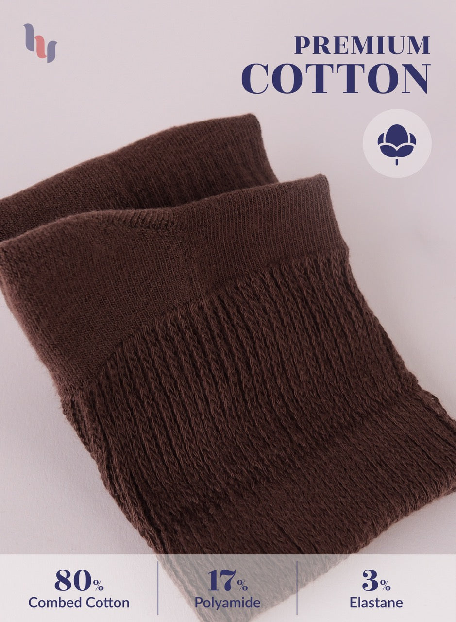 Brown knitted scarf with 'Premium Cotton' label and material composition details on a light background