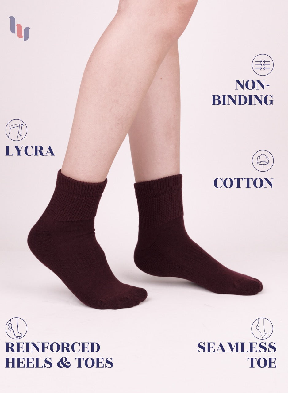 Burgundy socks with text highlighting features on a light pink background