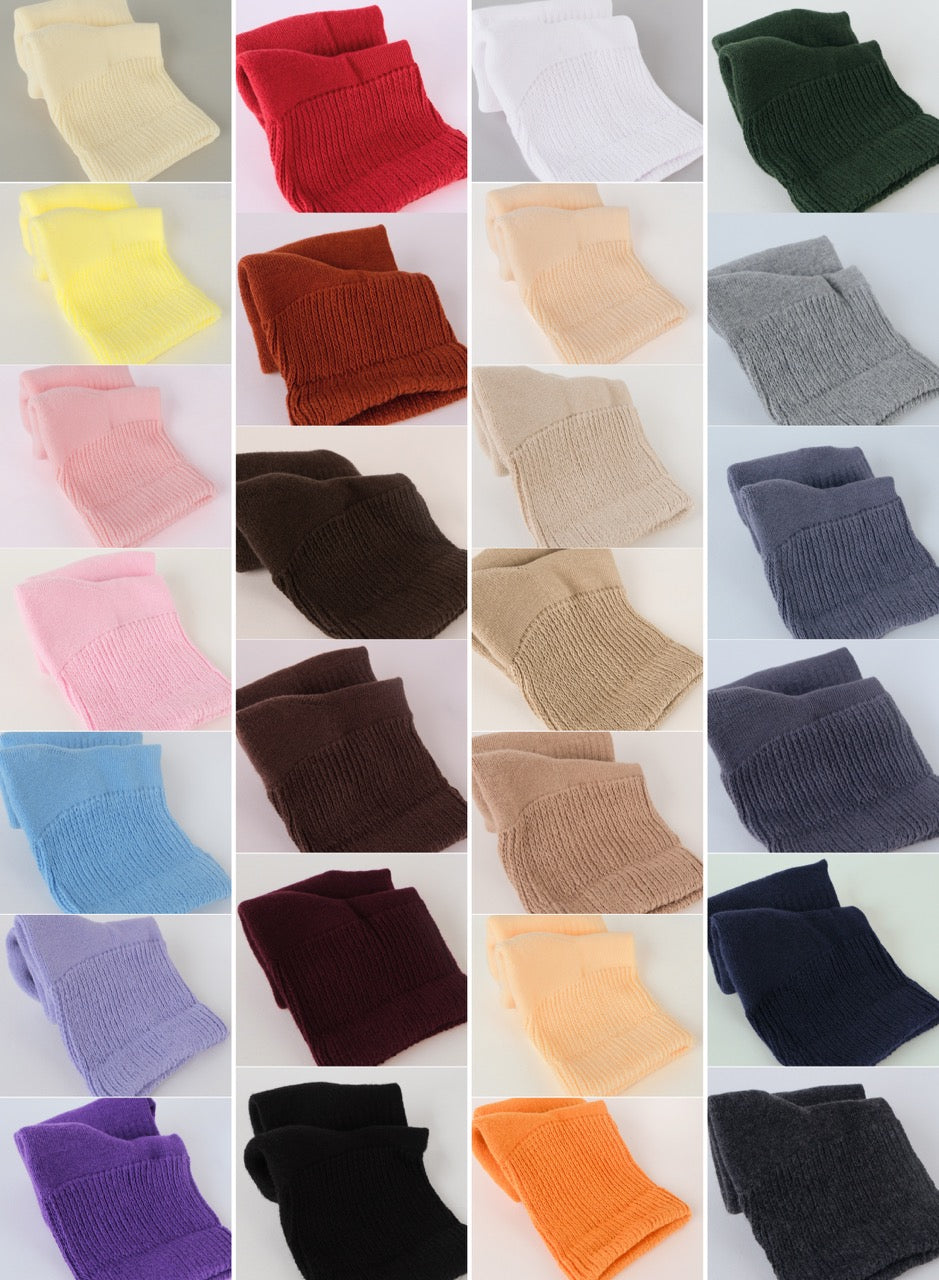 Collage of various colored knitted socks on a white background