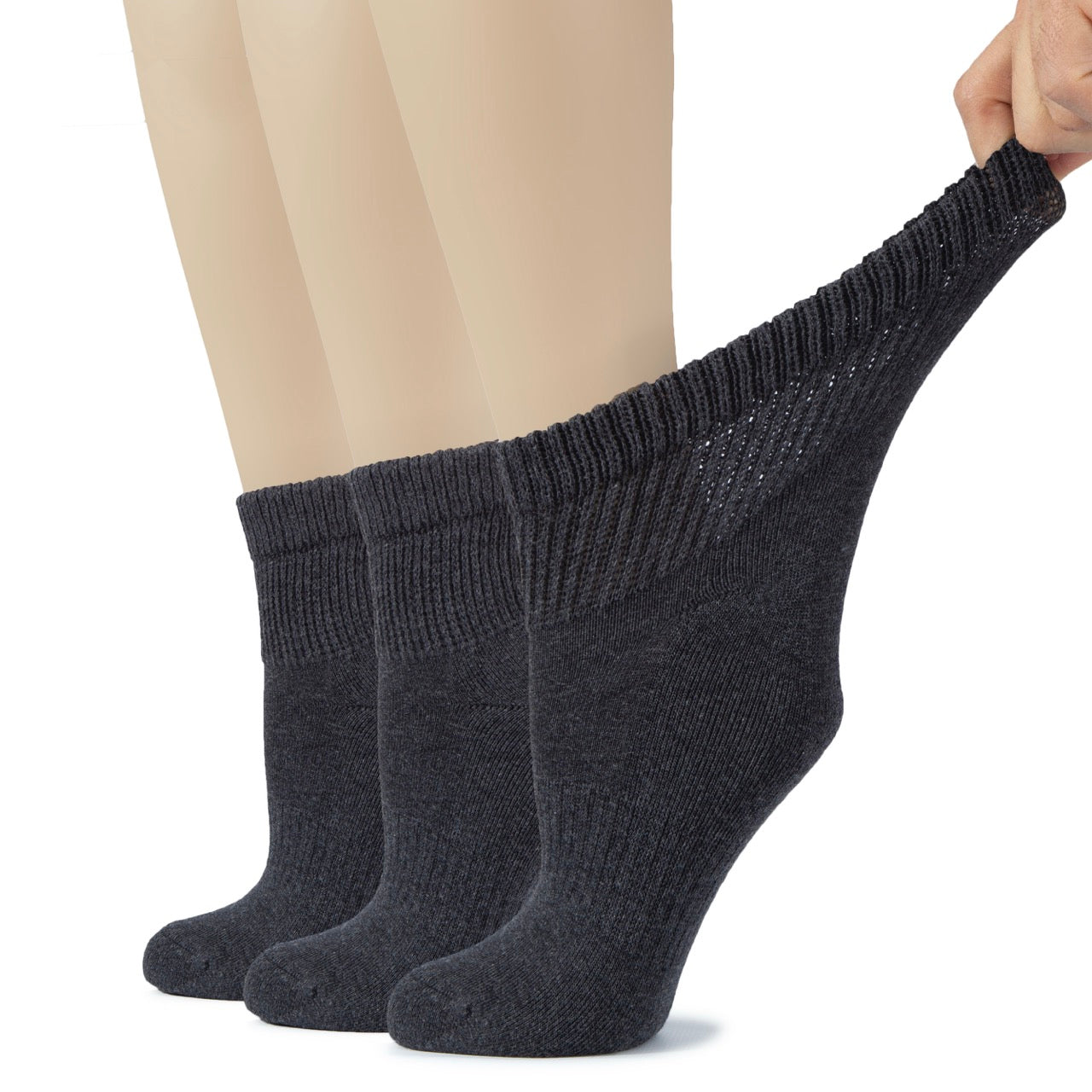 Dark gray socks being held up with a plain background