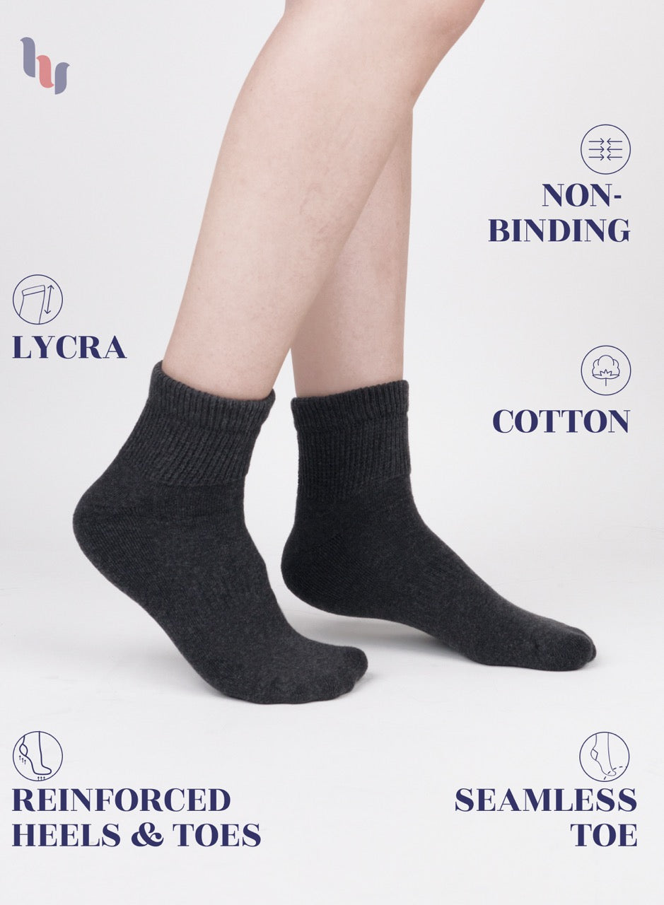 Dark grey socks with text highlighting features on a light gray background