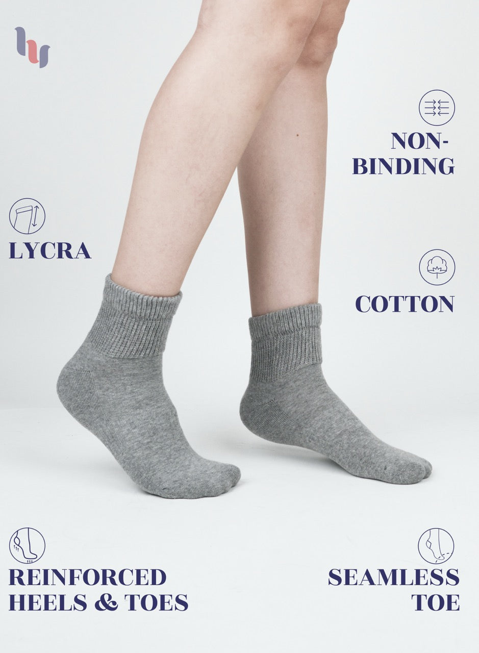 light gray socks worn by a person on a white background with product features highlighted.