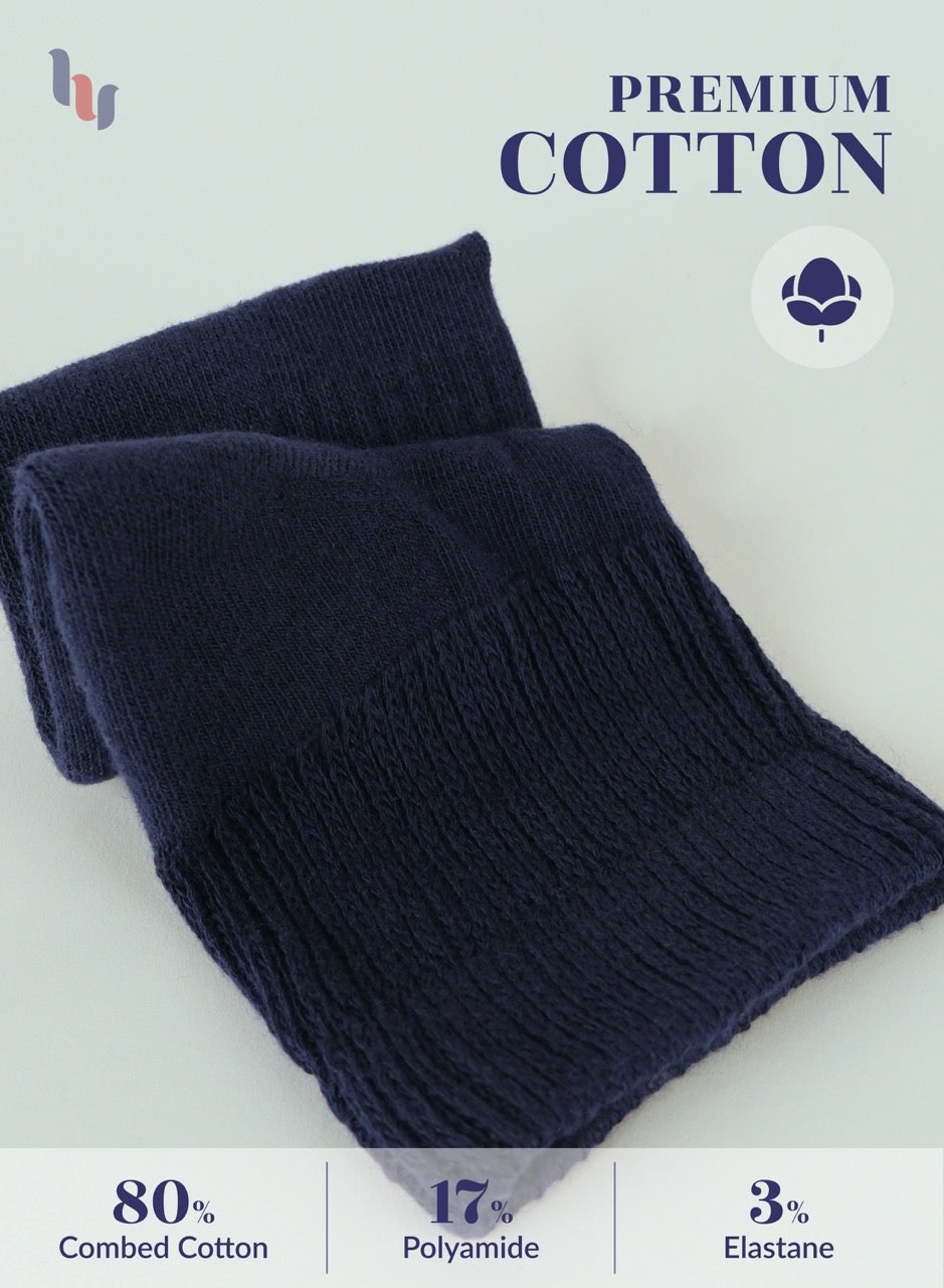 Folded navy blue fabric with 'Premium Cotton' text and material composition details on a light background