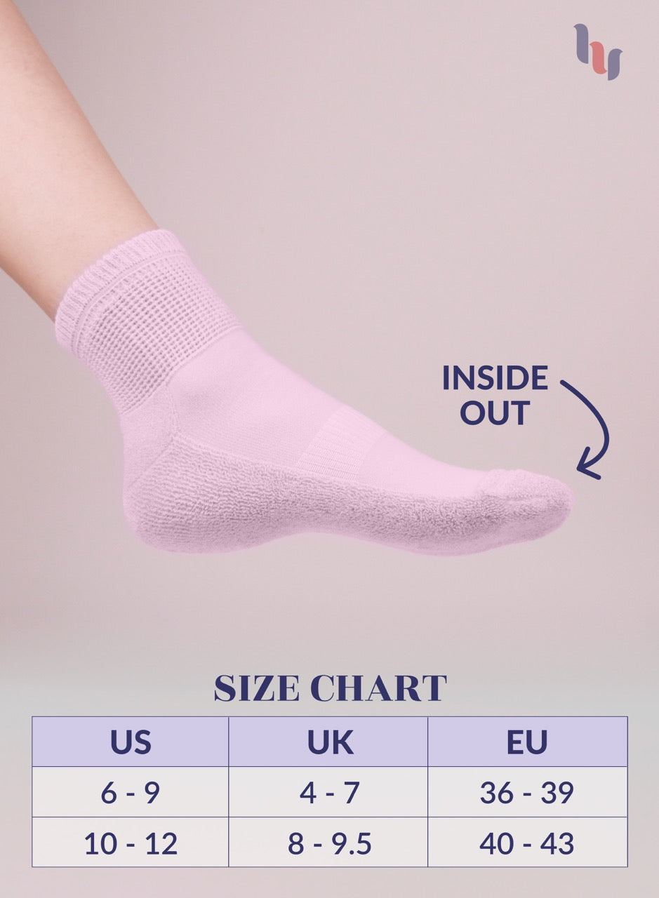 Pastel pink sock on a foot with size chart below on a light gray background
