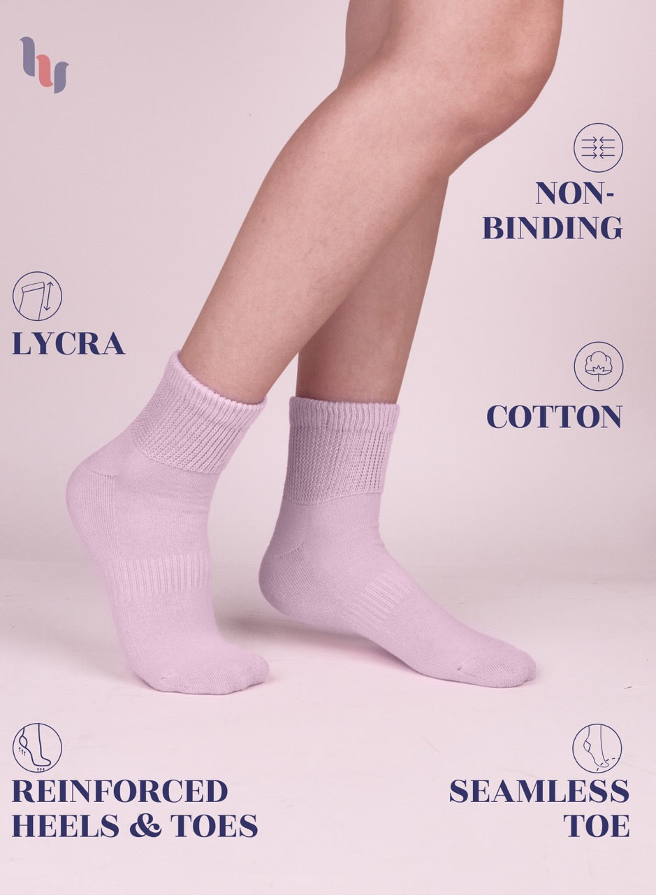 Pastel pink socks worn by a person on a light pink background with text highlighting features.