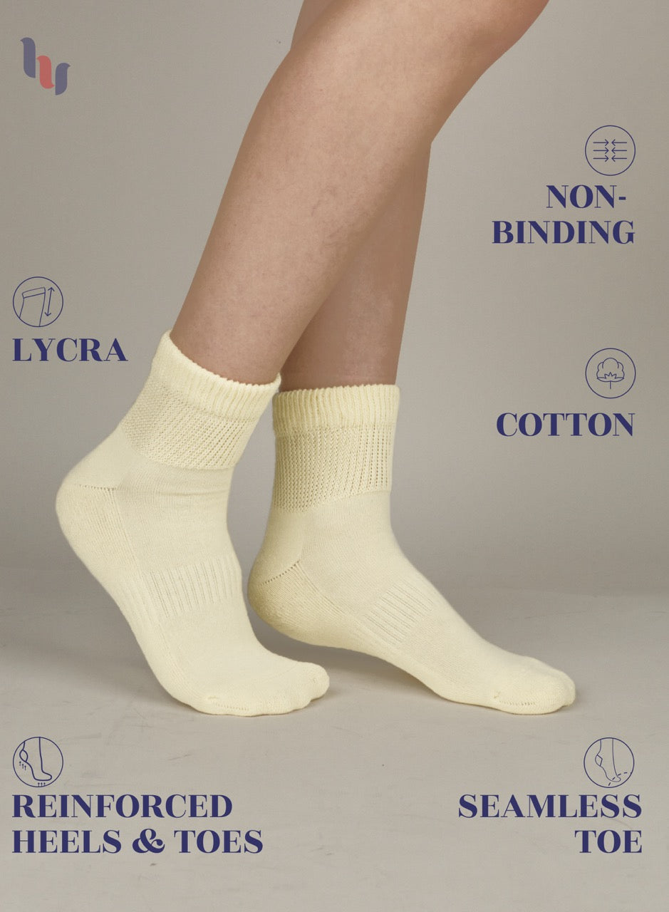 Pastel Yellow socks with text highlighting features on a neutral background