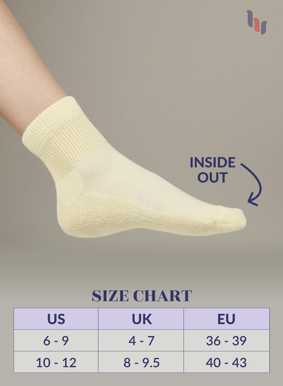 Pastel Yellow sock on a foot with 'Inside Out' label and size chart below on a gray background