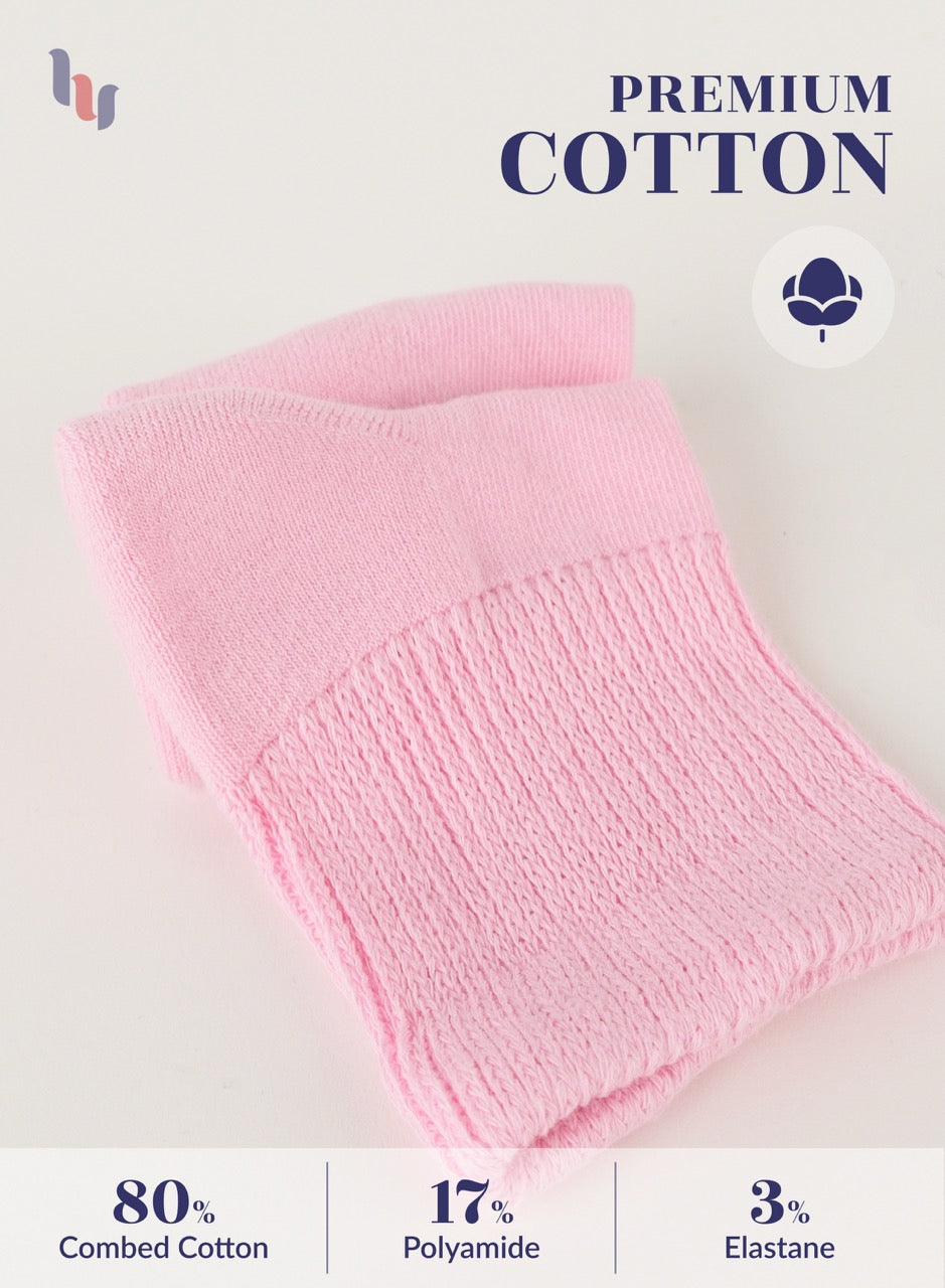 Pink knitted fabric with 'Premium Cotton' label and material composition details on a white background