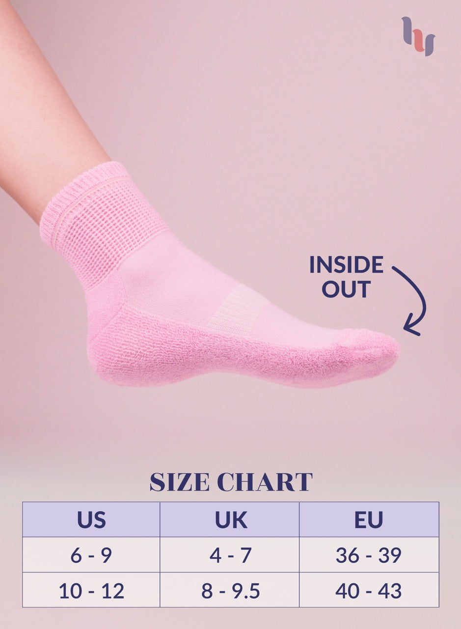 Pink sock on a foot with size chart below on a pink background