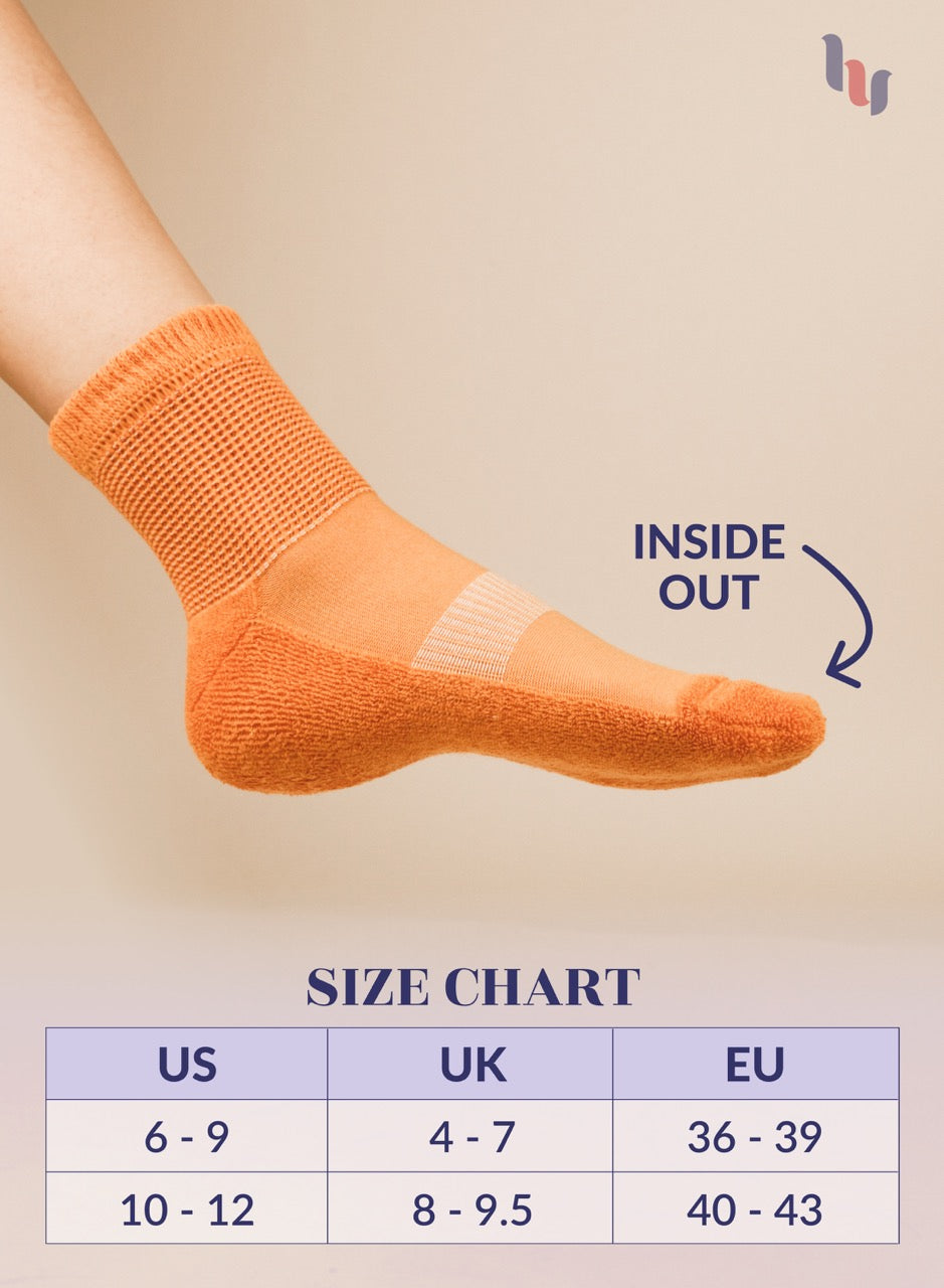 Pumpkin Orange sock on a foot with size chart below on a beige background