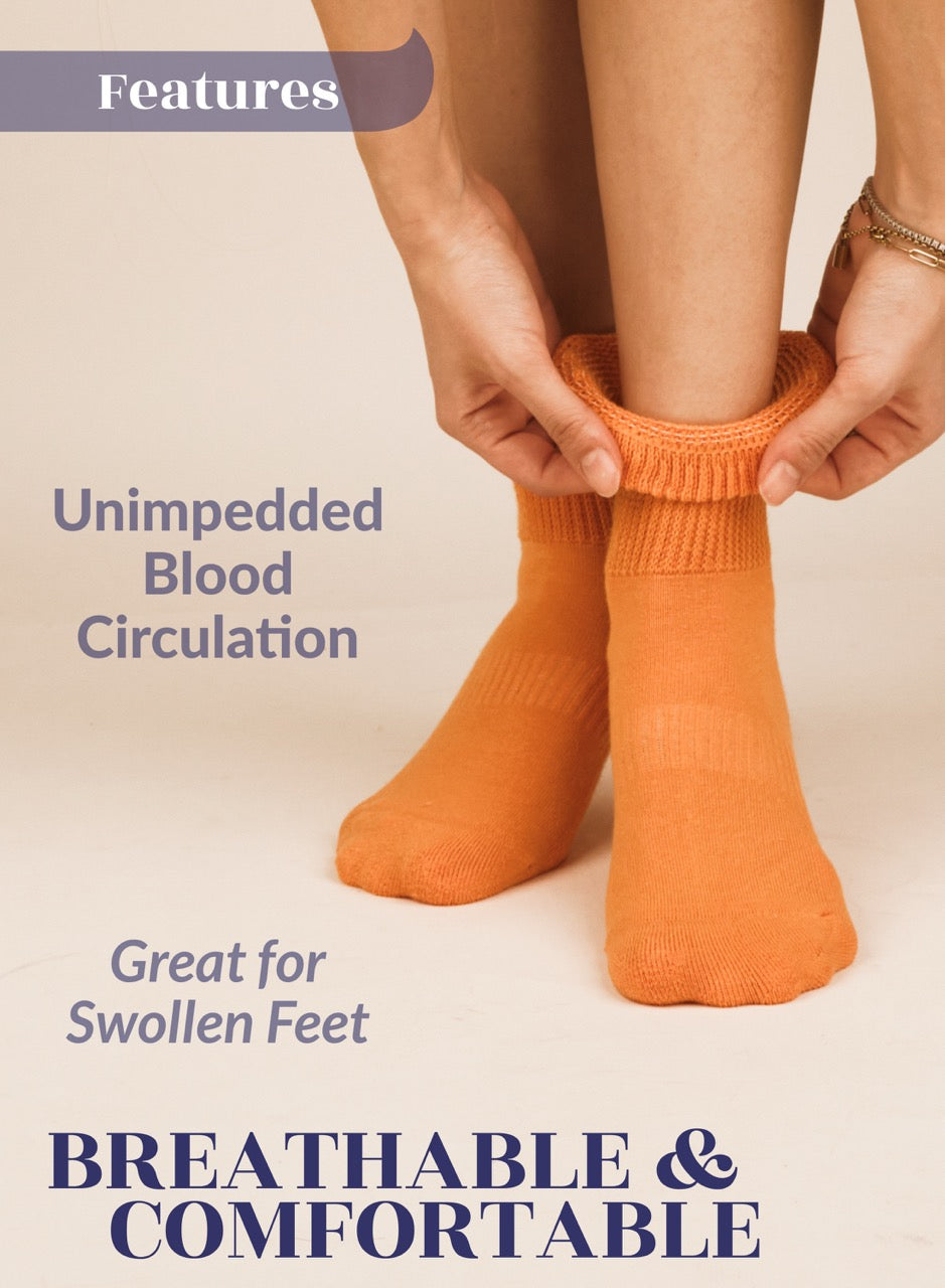 Person wearing Pumpkin orange socks with text about blood circulation and comfort on a beige background