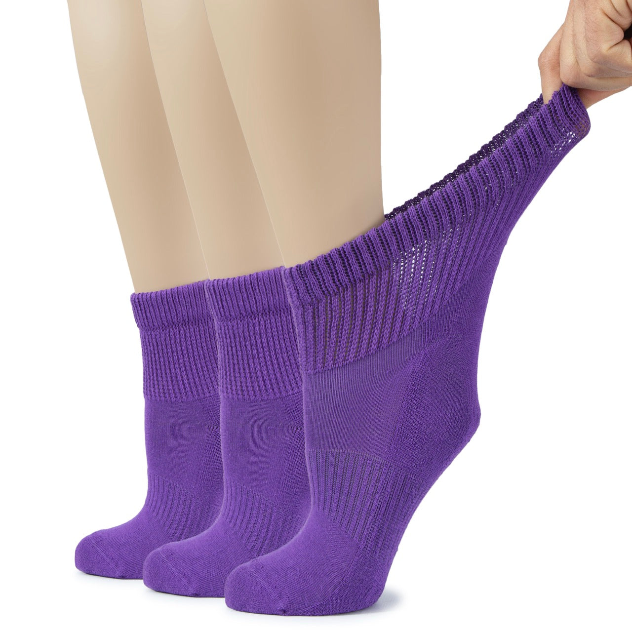 Purple socks being worn with a plain background