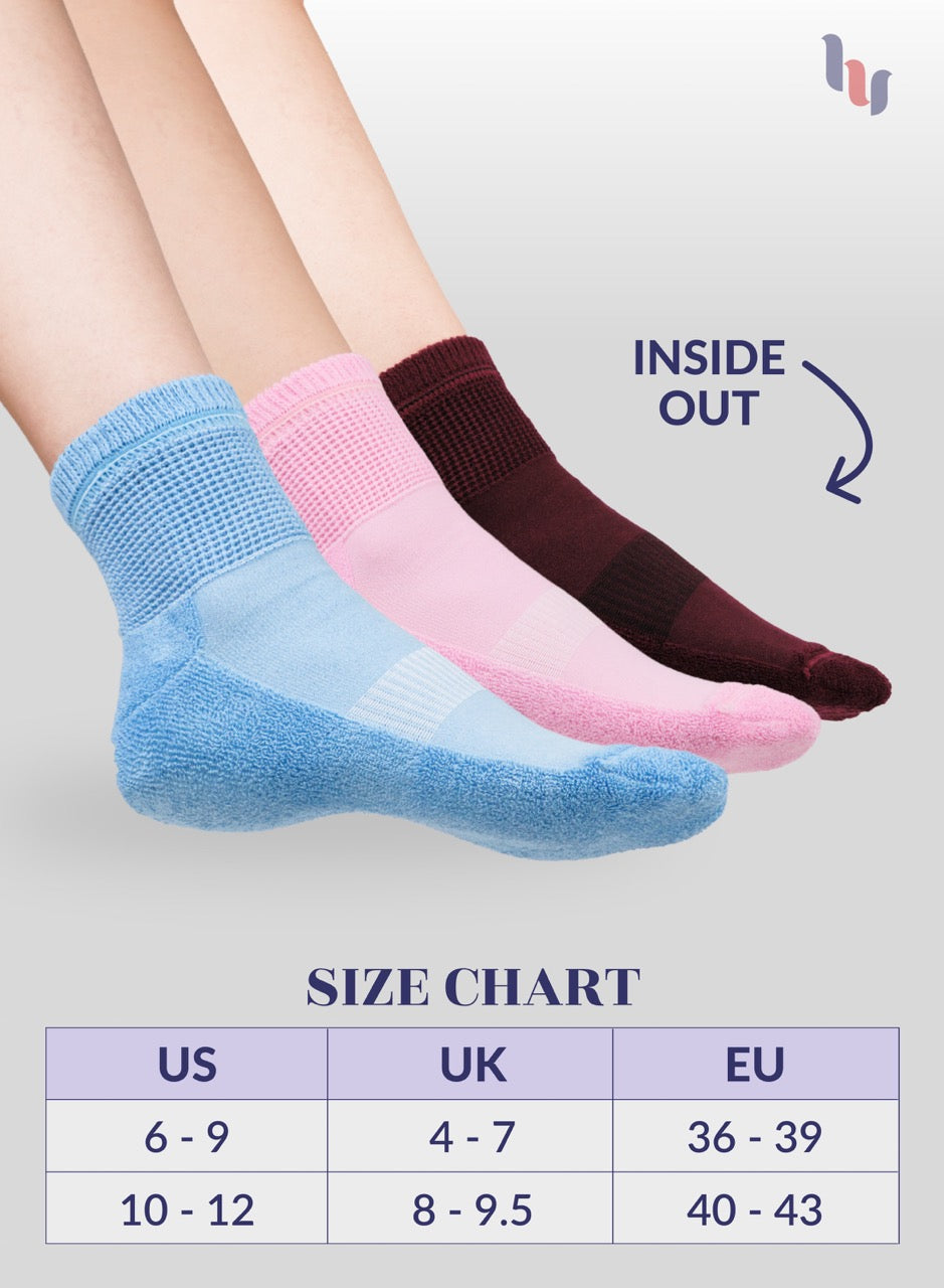 Three pairs of socks in blue, pink, and maroon with a size chart below on a light gray background.