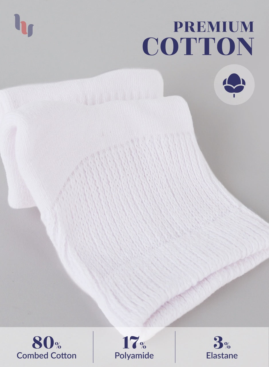 White towel with 'Premium Cotton' label and fiber content details on a gray background