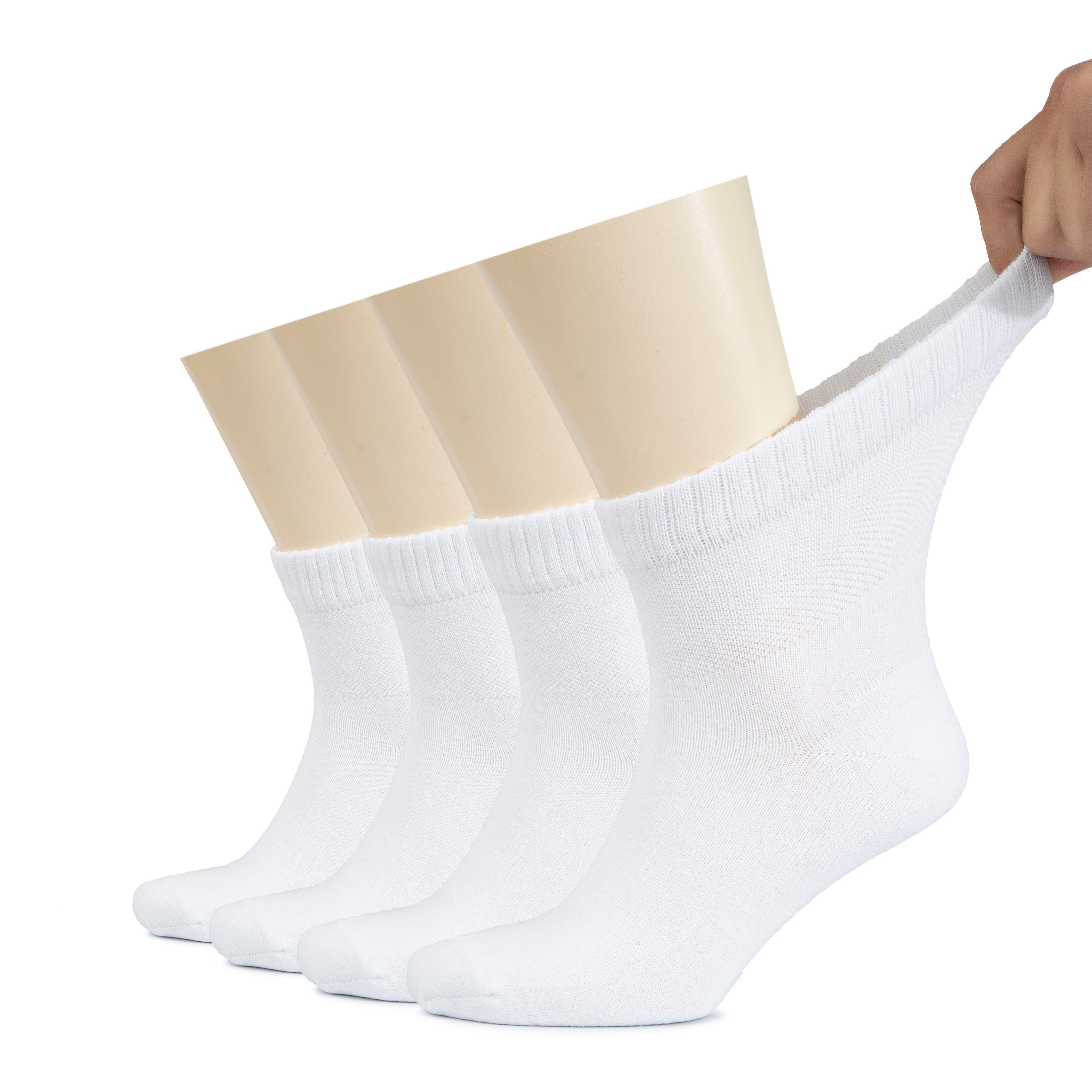 A man's foot wearing four pairs of white Men's Diabetic Ankle Socks, designed for comfort and support.
