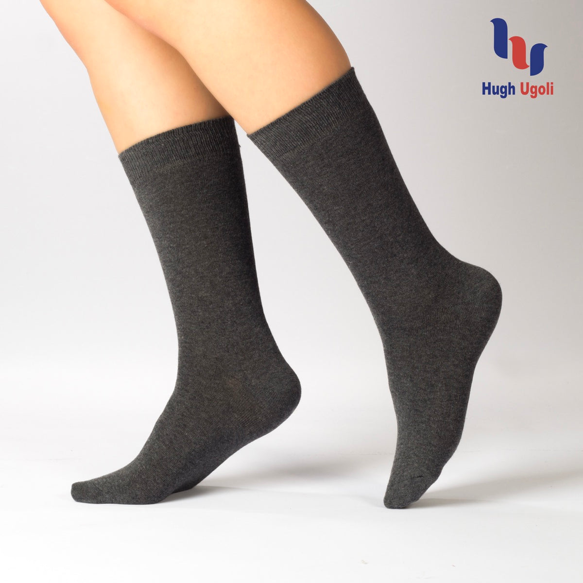 These Casual Cotton Dress Crew Socks feature "hugli" on the legs of a woman, adding a touch of personality to any outfit.