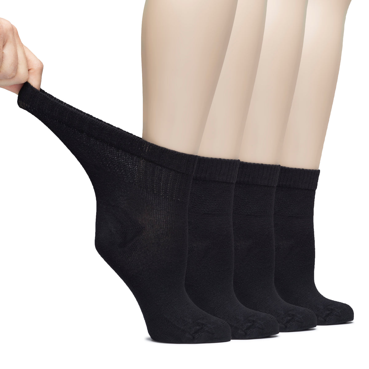 A photo of a woman's feet in black diabetic bamboo ankle socks, with one foot slightly in front of the other.