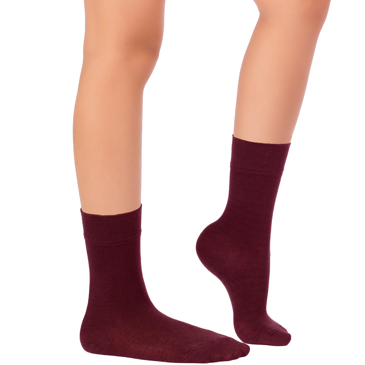 The picture showcases a pair of burgundy socks made of bamboo, intended for kids' dress crew, covering a woman's legs.