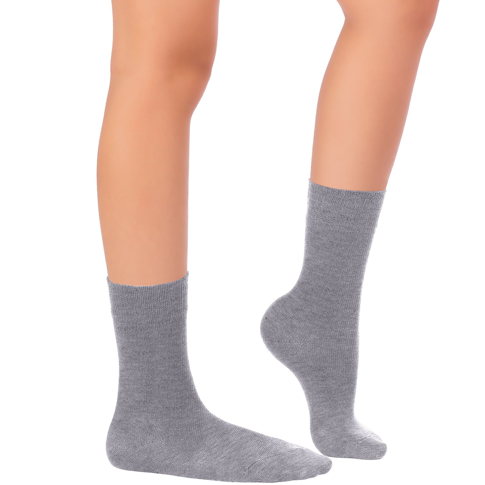 The picture showcases a pair of grey socks made of bamboo, intended for kids' dress crew, covering a woman's legs.